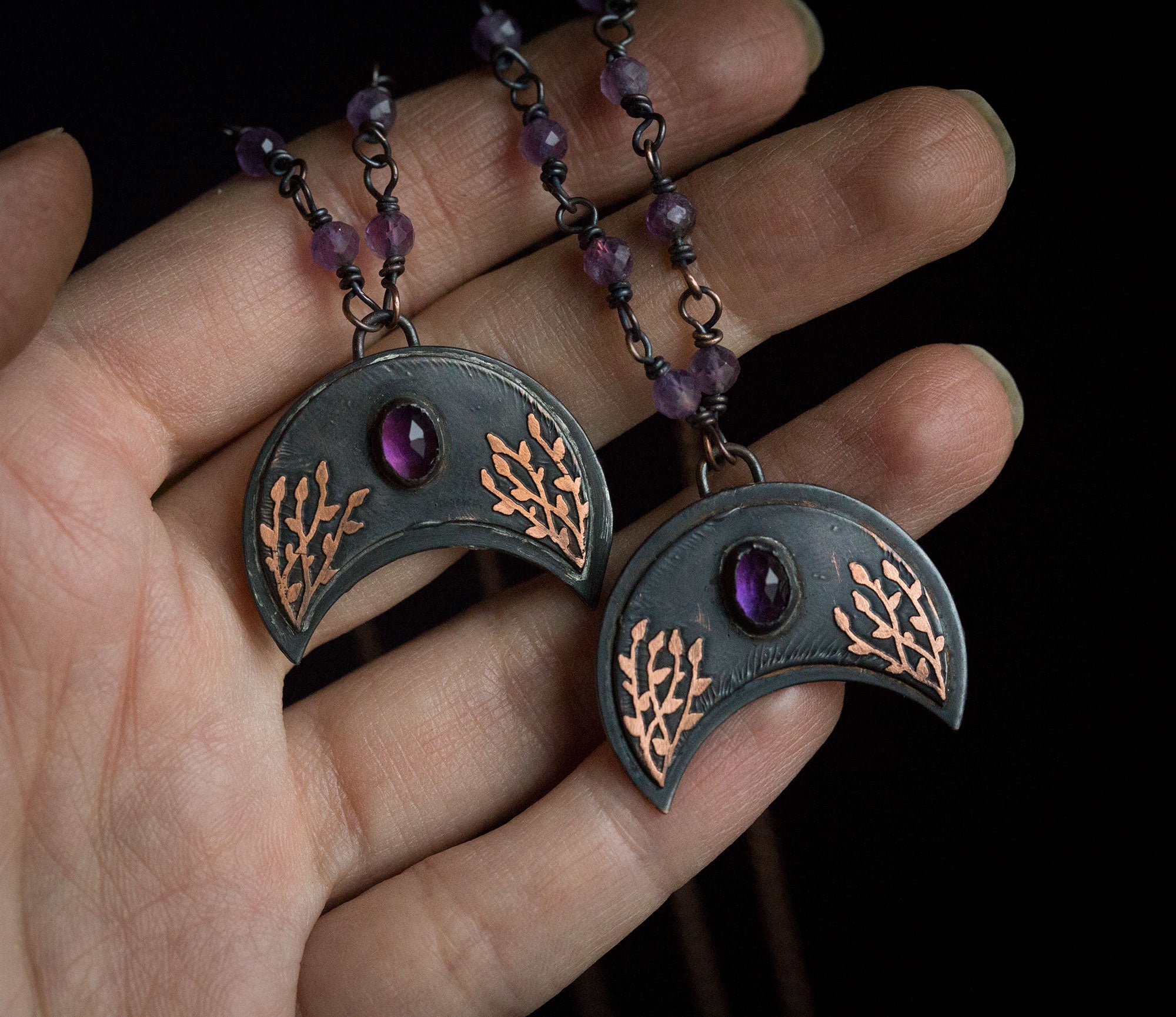 Ciemna lunula z roślinnym rysunkiem i ametystem